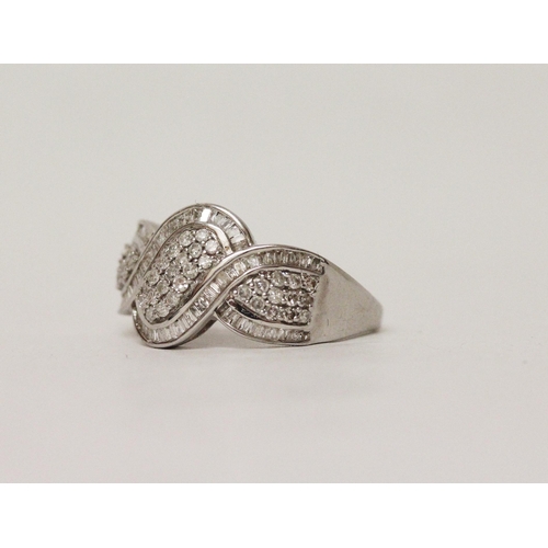 618 - A large modern diamond cluster ring designed as three panels of pave set brilliant and baguette cut ... 