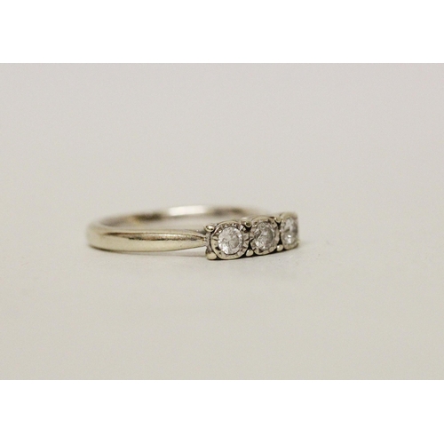 632 - A three stone modern diamond ring on a 9ct white gold band. Ring size L, gross weight 2.9 grams