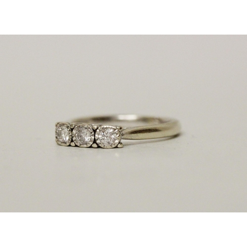 632 - A three stone modern diamond ring on a 9ct white gold band. Ring size L, gross weight 2.9 grams