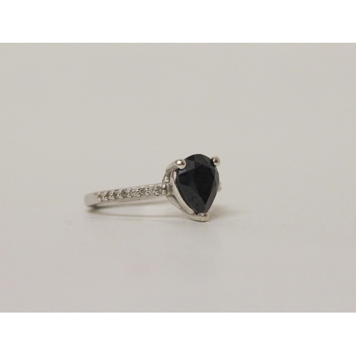 634 - A sapphire dress ring with a large teardrop shape sapphire claw set to diamond shoulders on a 14ct w... 