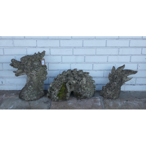 824 - A reconstituted stone three piece garden figure of a dragon