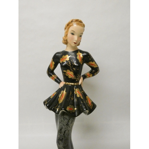 256 - A Goldscheider figurine of an Art Deco lady in a peplum black and gilt dress, impressed and printed ... 