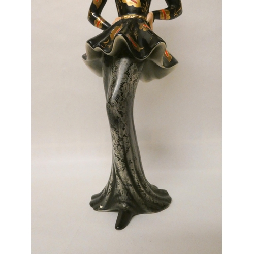 256 - A Goldscheider figurine of an Art Deco lady in a peplum black and gilt dress, impressed and printed ... 