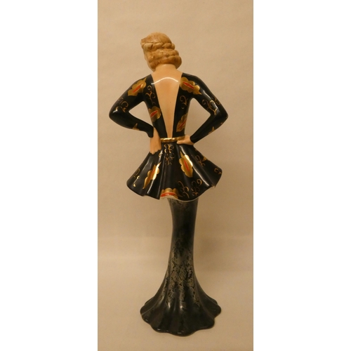 256 - A Goldscheider figurine of an Art Deco lady in a peplum black and gilt dress, impressed and printed ... 