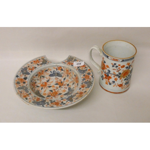 259 - An Imari shaving bowl with riveted restoration and a large Imari tankard (handle restored)