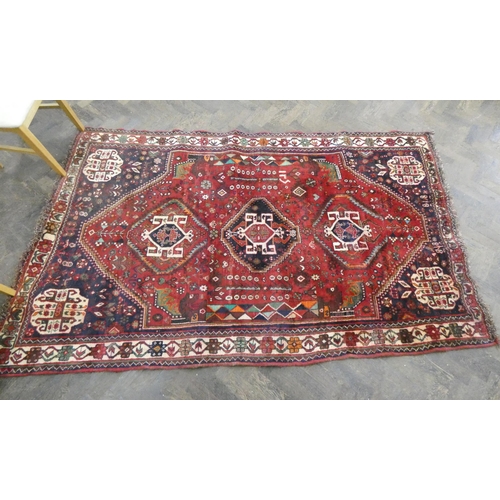 371 - A Persian woollen carpet measuring 8'3