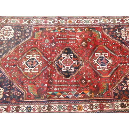 371 - A Persian woollen carpet measuring 8'3