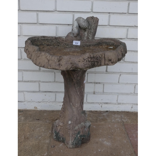 826 - A large bird bath with tree trunk and squirrels on base...