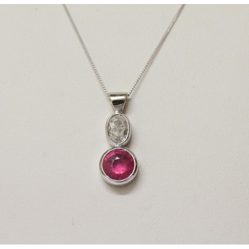 643 - A ruby and diamond pendant, collet set with an oval old cut diamond to a circular ruby, in 9ct white... 