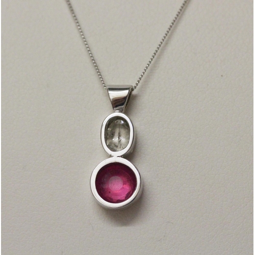 643 - A ruby and diamond pendant, collet set with an oval old cut diamond to a circular ruby, in 9ct white... 