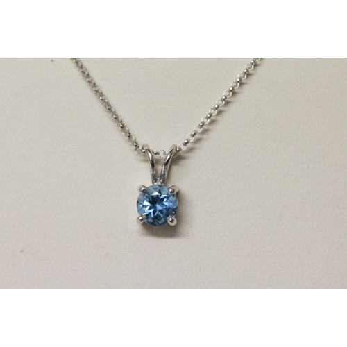 648 - A modern 14k white gold blue topaz solitaire pendant on 14k white gold chain, clasp marked 585. Gros... 