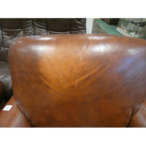 296 - A pair of tan leather easy chairs