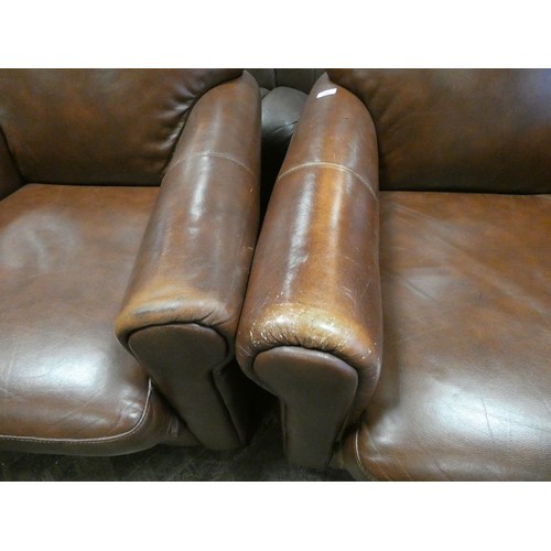 296 - A pair of tan leather easy chairs