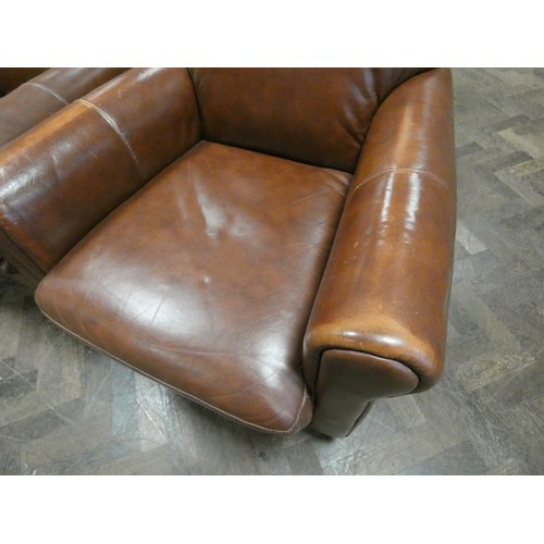 296 - A pair of tan leather easy chairs