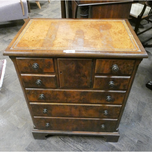 380 - An antique style burr walnut bachelors style chest with an inset brown leather top, widest part 24