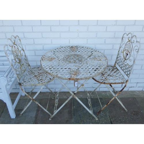 830 - A metal pierced painted folding garden bistro table with two matching folding chairs