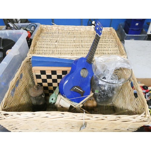 348 - A wicker basket with lift top lid containing chess set, two model boats, china figures, wooden squir... 