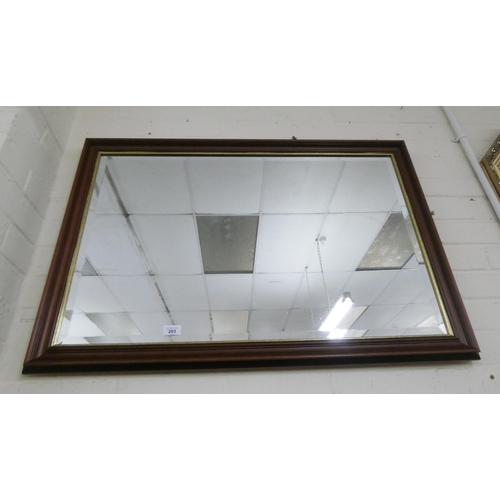 203 - A large bevelled wall mirror in mahogany frame