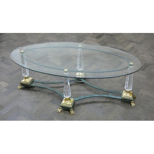 225 - A modern oval glass topped coffee table on glass and brass decorative stand