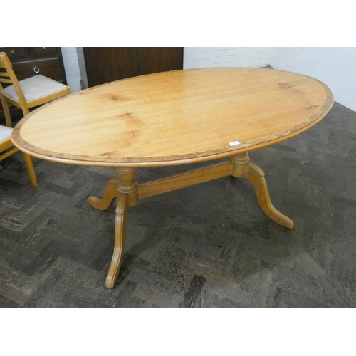 227 - A modern oval pine effect dining table with walnut cross banded top, 5'3