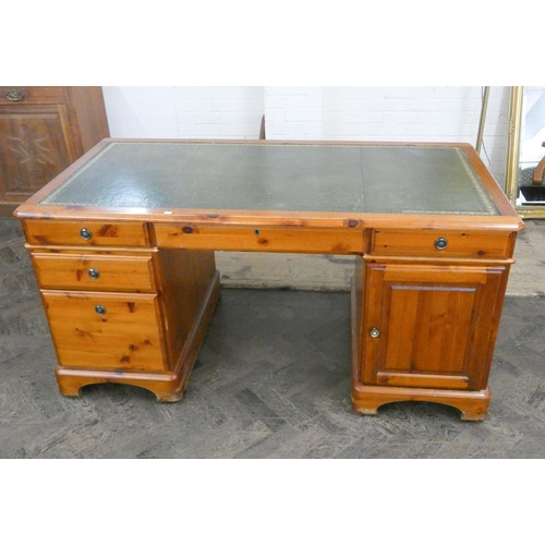 230 - A pine pedestal desk fitted drawers and cupboards with green leather top, 5' wide