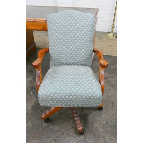 231 - A pine revolving reclining office elbow chair in green patterned covering