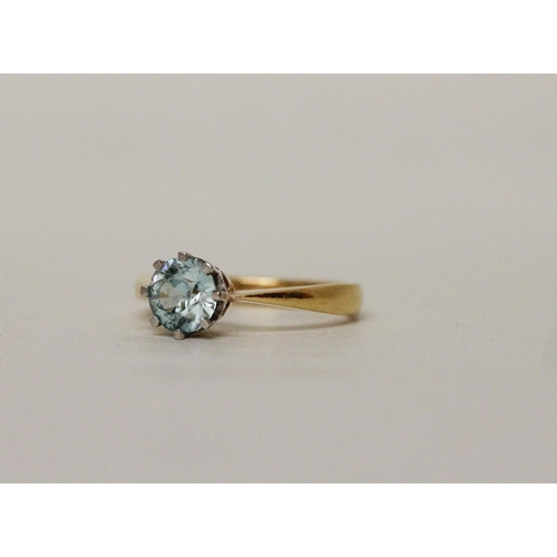 511 - A single stone blue topaz ring on 22ct yellow gold band . Hallmarked, ring size N, gross weight 4.6