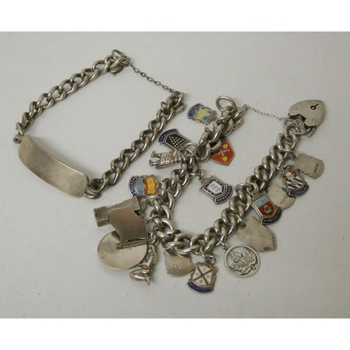 553 - A silver charm bracelet and a silver ID bracelet. Gross weight of 2 - 107g