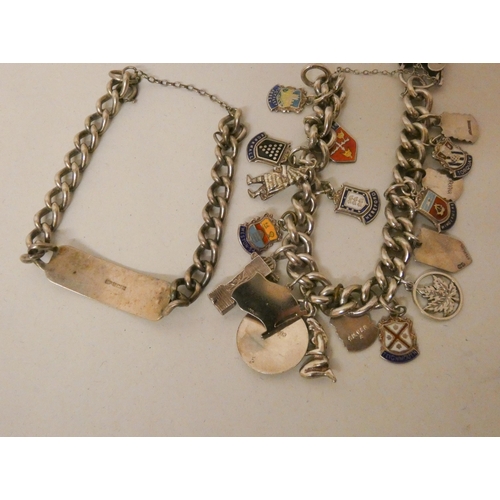 553 - A silver charm bracelet and a silver ID bracelet. Gross weight of 2 - 107g