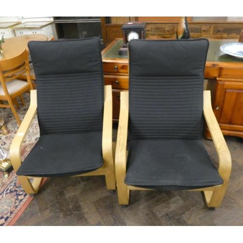 229 - A pair of modern sprung bent wood framed easy chairs in black covering