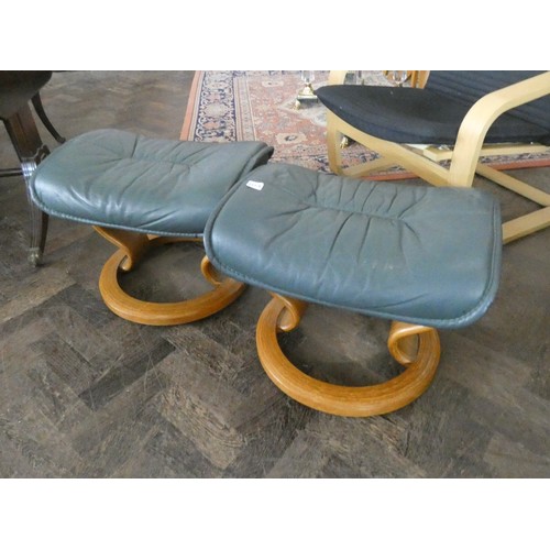 229A - A pair of Ekornes green leather footstools