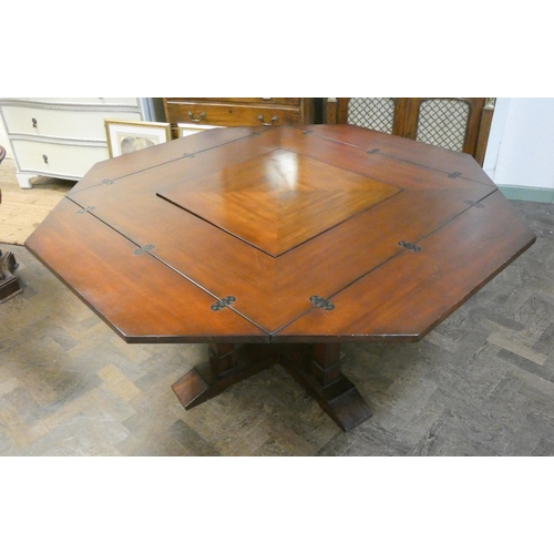 1 - An unusual mahogany octagonal swivel top dining table, with folding leaves to make a square table on... 