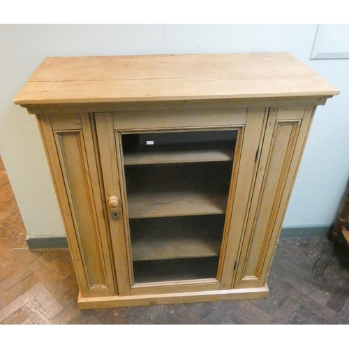 10 - A stripped and waxed pine cabinet with single glass door and interior shelves, 37