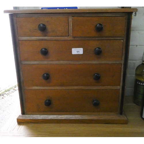 11 - A miniature mahogany chest of three long and two short drawers with knob handles, 17