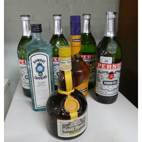 26 - A collection of four bottles of Pernod, a bottle of Bombay Sapphire gin, a bottle of Grand Marnier a... 