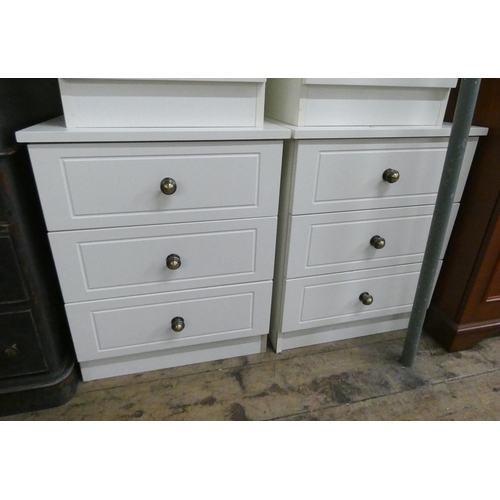 27 - A pair of modern white three drawer bedside chests