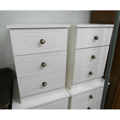 28 - A pair of slightly smaller white, three drawer bedside chests