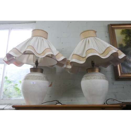 43 - A pair of large cream marble effect table lamps with fancy frilled cream shades