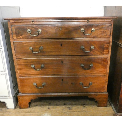 5 - A Georgian mahogany bachelors chest of four long drawers with brushing slide standing on bracket fee... 