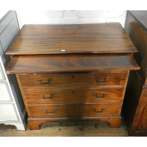 5 - A Georgian mahogany bachelors chest of four long drawers with brushing slide standing on bracket fee... 