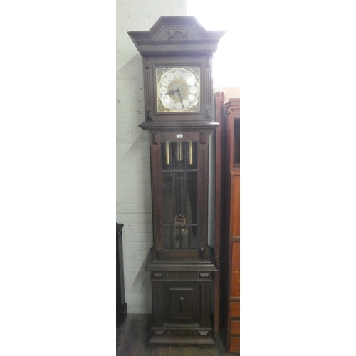 50 - A mid-twentieth century chiming grandfather clock with brass and silver effect dial in oak and glaze... 