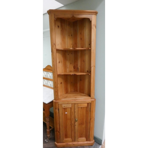 52 - A stripped pine open corner cabinet with cupboards under