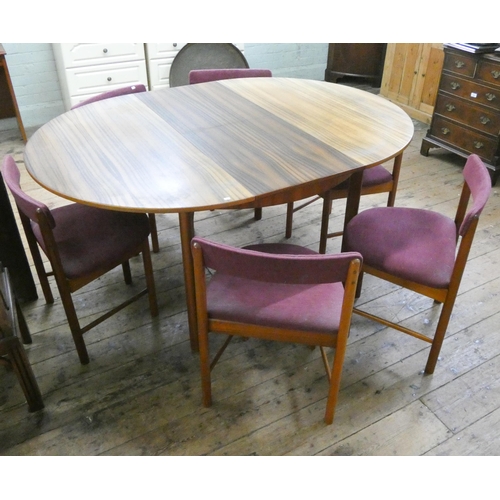 59 - A 1960's/1970's Mackintosh teak oval extending dining table with extending leaf and six shaped teak ... 