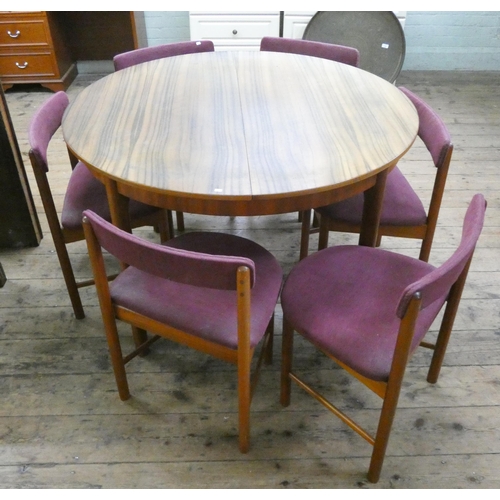 59 - A 1960's/1970's Mackintosh teak oval extending dining table with extending leaf and six shaped teak ... 