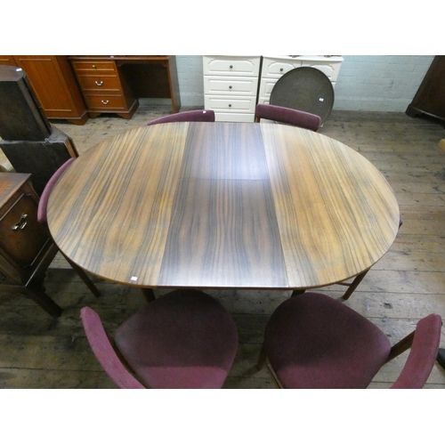 59 - A 1960's/1970's Mackintosh teak oval extending dining table with extending leaf and six shaped teak ... 