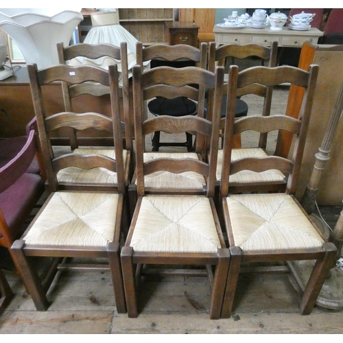 61 - A set of six oak high ladderback dining chairs with rush seats