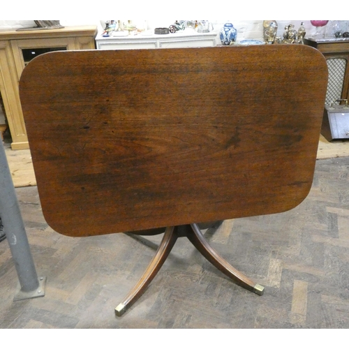 7 - A Georgian mahogany flip top breakfast or dining table on single pillar quadruple base with brass fe... 