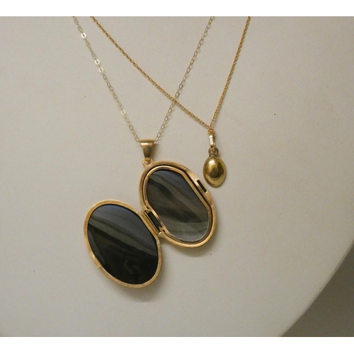 544 - 9ct gold coffee bean pendant on chain and a large oval 9ct gold locket on chain. Gross weight 6.5g