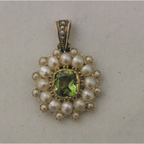 545 - A large oval peridot and seed pearl cluster pendant, unmarked yellow metal tests as gold, 28mm long ... 