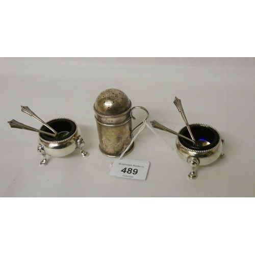 489 - A silver pepper shaker and a pair of Victorian silver salt cellars with blue glass liners, and four ... 